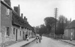 Image: Main Street with numbers 4-7 on the left. On the right entrance to Home Farm